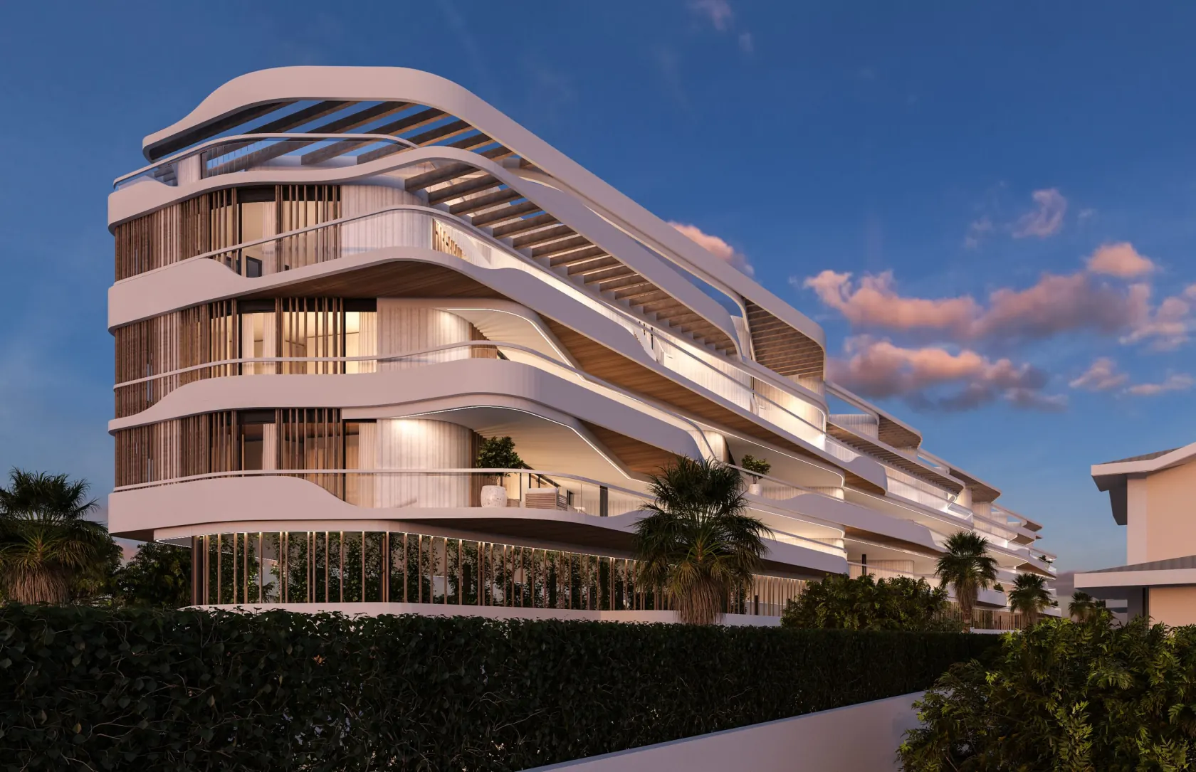 Fachada iluminada del Residencial La Patá al atardecer